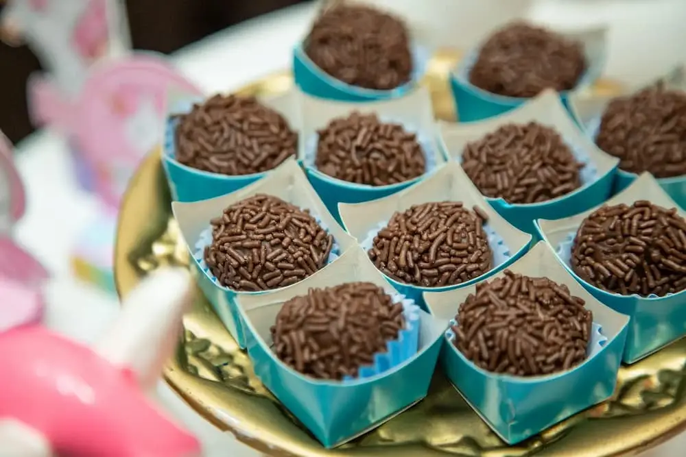 Brigadeiros artesanais dispostos em conjunto sobre uma bandeja elegante